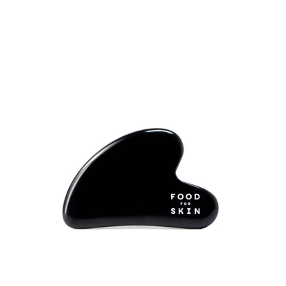 Packshot van Gua Sha massagesteen van lavaglas